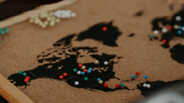 Corkboard world map with pins marking mission partners across the 10/40 window